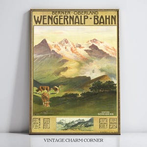 以下が含まれることがあります： 上部に「BERNER OBERLAND WENGERNALP-BAHN」、下部に「STATION SCHEIDEGG」の文字が記されたヴィンテージ風の旅行ポスター。雪を頂いた山々、緑の斜面、そして牧草地で草を食む茶色の牛たちが描かれた山岳風景のイラスト。