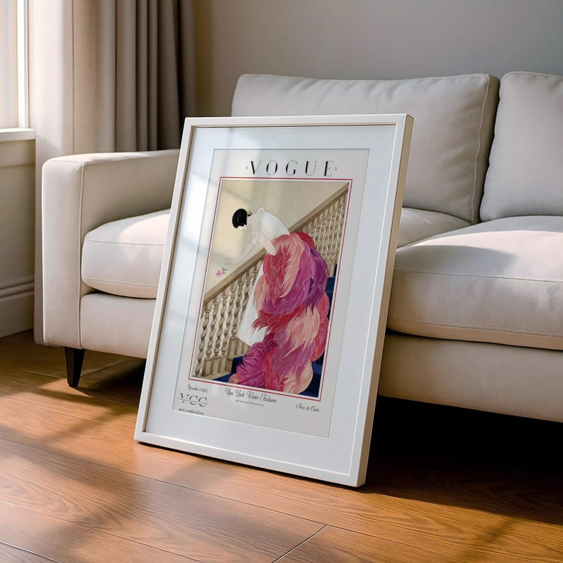 Digital Download Of A November 1 1924 Vogue Cover By George Wolfe Plank Showing An Art Deco Woman In A White Winter Gown Leaning Over A Staircase Toward A Pink Rose With Dramatic Pink Feathered Train. Printable Vintage Wall Decor For Cottagecore Farmhouse Glam Gallery Walls Fashion History Lovers And Gift Buyers.