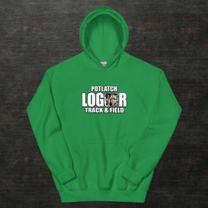 May include: A vibrant green hoodie featuring the text "POTLATCH LOGGER TRACK & FIELD" in white and black. The sweatshirt has a drawstring hood and a front pocket. The design is centered on the chest.