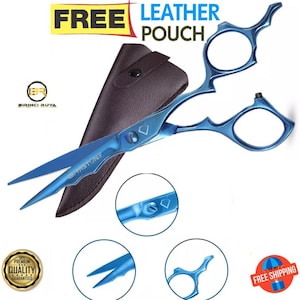 May include: Blue hair cutting shears with a black leather pouch. The shears feature a diamond-shaped design on the handle and the words "Gemstone" on the blade. The pouch has a snap closure. The image also includes a close-up of the shears and a free shipping label.