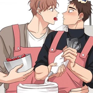 May include: An illustration of two people preparing a cake. One person wears a "Happy Birthday" headband and offers a strawberry. The other person, wearing a party hat, decorates the cake with frosting. Both wear pink aprons.