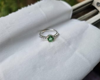 Tourmaline ring with simple design and pretty zircons on side
