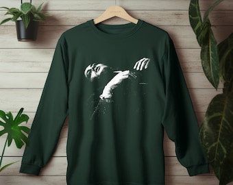 May include: A dark green long-sleeved t-shirt with a white graphic print of a person embracing themself.