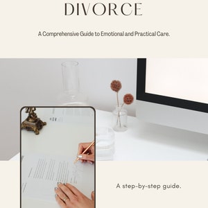 May include: A book cover with the title "Navigating Divorce: A Comprehensive Guide to Emotional and Practical Care." The cover features a photo of a hand signing a document, with a computer monitor and a vase of dried flowers in the background. The text "A step-by-step guide. By Rahy K." is also on the cover.