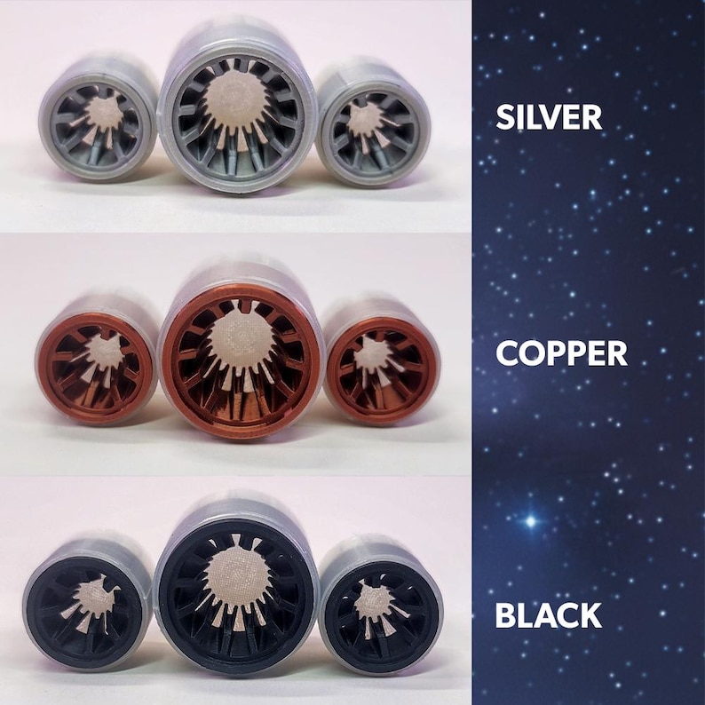 May include: Three bottle stoppers in silver, copper, and black. Each stopper has a cylindrical design with a detailed inner pattern. The image includes the text "SILVER", "COPPER", and "BLACK" on a starry background.