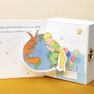 Mini-Spieluhr „Der kleine Prinz“ in Buchform |  Einzigartiges Geschenk für Buchliebhaber, Fans von Der kleine Prinz und Romantische Anlässe | Weihnachten