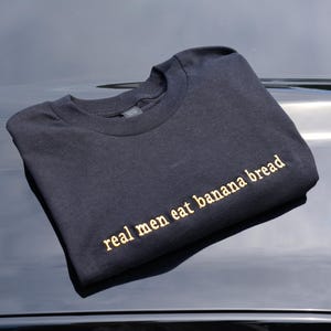 Embroidered 'real men eat banana bread' T-Shirt, Short Sleeve, Modern Classic fit, Unisex, Adult