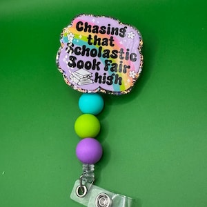 Funny “Chasing That Scholastic Book Fair High” Badge Reel – Retro Teacher & Librarian ID Holder with Beads