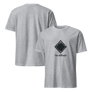 May include: Two heather gray t-shirts. The front shirt has a black diamond graphic and the text "I'm difficult" printed below it. The second shirt is visible from the back.