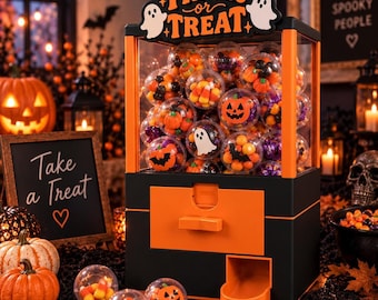May include: A black and orange vending machine filled with clear plastic capsules containing Halloween-themed candies and charms. The top sign reads "TRICK or TREAT" with two white ghost illustrations. The machine has a dispensing slot.