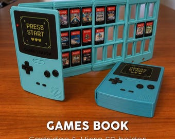 May include: A light blue Games Book cartridge and micro SD card holder, designed to resemble a retro handheld gaming device. The holder is open, displaying several game cartridges. The text "PRESS START" is visible on the front.