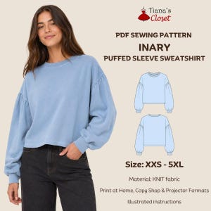 May include: A PDF sewing pattern for the Inary puffed sleeve sweatshirt by Tiana's Closet. The design features a light blue sweatshirt with long, voluminous sleeves and a crew neckline. The pattern is available in sizes XXS to 5XL for knit fabric.