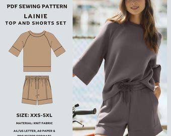May include: A PDF sewing pattern for the Lainie top and shorts set. The image shows a sketch of the top and shorts in a tan color, and a person wearing the set in a dark gray color. The pattern includes sizes XXS-5XL and is made with knit fabric.