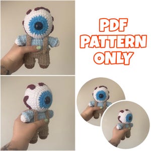 May include: A crochet doll featuring a large white spherical head with a prominent blue iris and black pupil, topped with dark red spots. The body wears a light blue shirt and tan overalls with straps. The text PDF PATTERN ONLY is displayed.