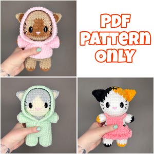 May include: Three crocheted cat dolls are shown, each with a unique outfit. One is in a pink hoodie, another in a green jumpsuit, and the third in a pink dress. The image also displays the text "PDF PATTERN ONLY" in orange.