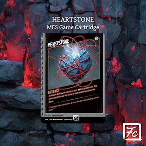 May include: A Heartstone MES Game Cartridge card featuring a blue heart wrapped in red string, with the word "HEARTSTONE" at the top. The card has text describing its artifact abilities and a quote about true heartstones.