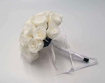 May include: A white bridal bouquet made of white roses with a white satin ribbon.