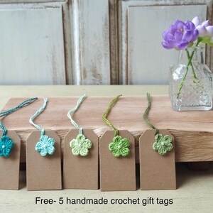 May include: Five handmade crochet gift tags with green and blue flowers. The tags are attached to brown card stock with twine. Free - 5 handmade crochet gift tags.