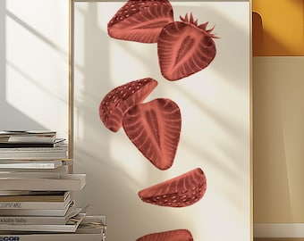 May include: A framed art print featuring a vintage-style illustration of several sliced strawberries in shades of red. The strawberries appear to be floating against a cream-colored background, creating a dynamic composition. The frame is a light wood color.