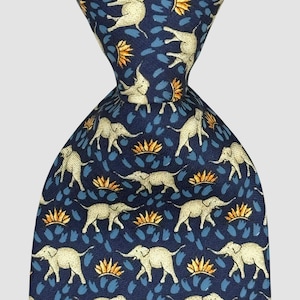May include: A navy blue tie featuring a repeating pattern of light beige elephants, gold and blue floral motifs. The tie is knotted, highlighting the intricate design. A smart accessory for formal or business wear. The tie's length is approximately 147 cm.