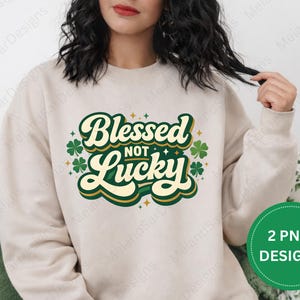 May include: A beige sweatshirt with the text "Blessed not Lucky" in green and gold, with shamrock and star accents. A green circle with the text "2 PNG DESIGNS" is in the lower right corner.