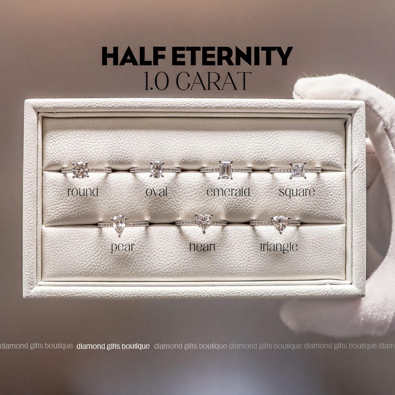 a collection of six diamond engagement rings, each with a unique cut and shape, presented in a white display case.