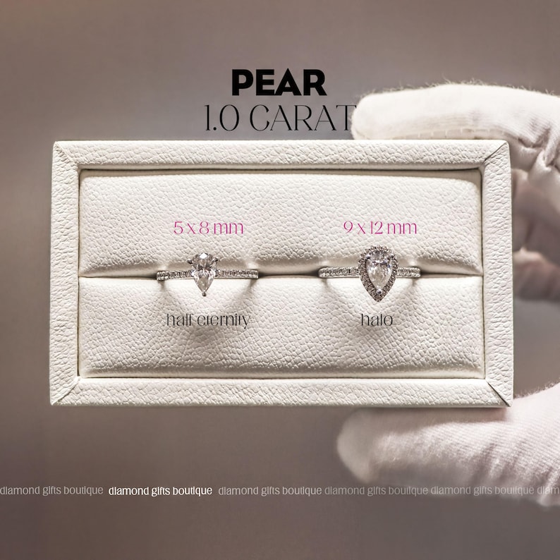 two diamond engagement rings displayed in a white jewelry box, with a hand wearing white gloves holding the box.