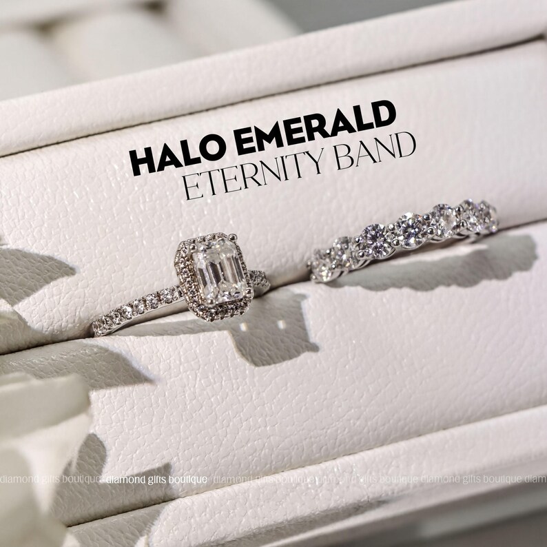 A close-up of two diamond engagement rings on a white surface, with the text "HALO EMERALD ETERNITY BAND" displayed above them.