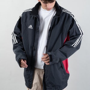 May include: A black and red windbreaker jacket with white stripes and the Adidas logo on the left chest.