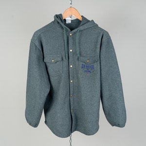 May include: A gray hooded button-up shirt with a blue embroidered logo that says "Sea Gallion" and "California" on it.