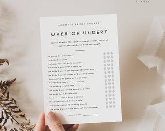 May include: A printable bridal shower game called "Over or Under?" with a list of statements about the bride and groom. Players guess if the answer is over, under, or exactly the number stated. The game is printed on white paper with a gray border.