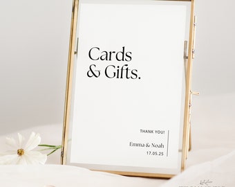 May include: A gold-framed sign with white cardstock that reads "Cards & Gifts." Below the text is "Thank You! Emma & Noah 17.05.25" and the text "WILDLY SIMPLE Studio" at the bottom.