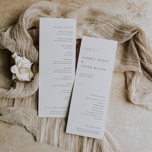 May include: Wedding ceremony program with a minimalist design. The program includes the names of the bride and groom, Audrey Scott & Jacob Miller, the date of the wedding, and the order of the ceremony. The program is printed on white cardstock with black text.