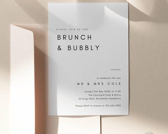 May include: A white wedding invitation with black text. It reads "Please join us for Brunch & Bubbly to celebrate the new Mr. & Mrs. Cole" and includes the date, time, location, and RSVP information.