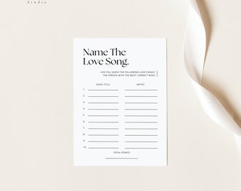 May include: A printable game card with the title "Name The Love Song." The card has a table with two columns labeled "Song Title" and "Artist." There are 10 rows for players to fill in the names of love songs.
