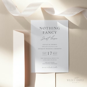 May include: A white wedding invitation with black text. The invitation reads "Nothing Fancy Just Love" and includes the names Cecilia & Thomas, the date Saturday, 17th May, and the time 3:00 PM. The invitation also includes the location of the wedding ceremony, The Old Chapel, Winchester, Hampshire.