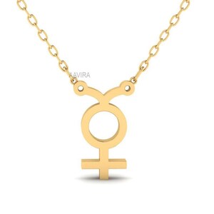 May include: A gold necklace with a pendant in the shape of the symbol for Venus. The pendant is a simple, stylized design.