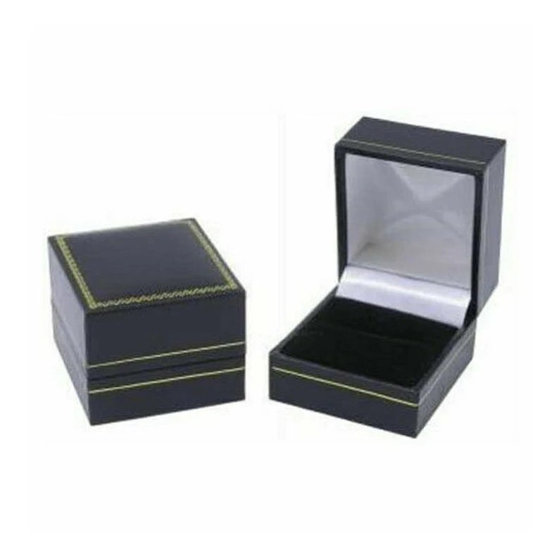 May include: Two black jewelry boxes, one closed and one open. The closed box is square with gold trim. The open box reveals a black velvet interior and a white satin lining. The boxes are designed to hold rings or other small jewelry items.