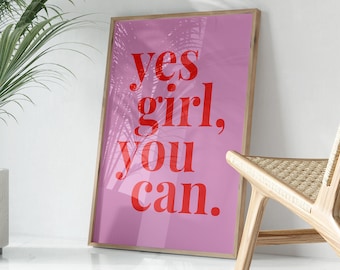 May include: A pink framed poster with the text "yes girl, you can." in red letters. The poster has a palm tree silhouette overlay.