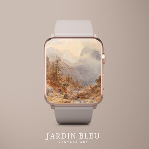Könnte beinhalten: Eine Smartwatch mit hellgrauem Armband und roségoldfarbenem Gehäuse. Das Zifferblatt zeigt ein Vintage-Landschaftsgemälde mit Bergen und Bäumen. Der Text "JARDIN BLEU VINTAGE ART" ist unten zu sehen.