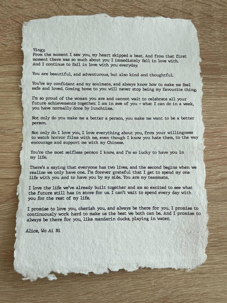 May include: A handwritten letter on textured paper with the text "Yingy" at the top. The letter is a heartfelt message of love and commitment, signed "Alice, Wo Ai Ni" at the bottom. The paper has a deckled edge.