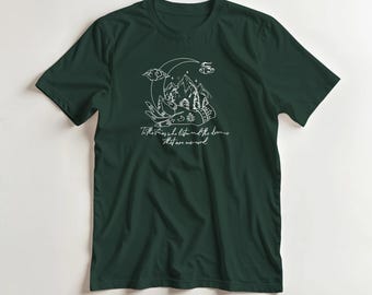 May include: Dark green t-shirt with a white graphic of a mountain range, moon, and clouds inside a hand. The text "To the ones who listen and the dreams that are un-told" is below the graphic. A casual tee for everyday wear.