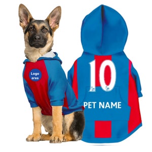 May include: Blue and red dog jersey with a white number 10 and the text "PET NAME" on the back. The jersey has a hood and a logo area on the front.