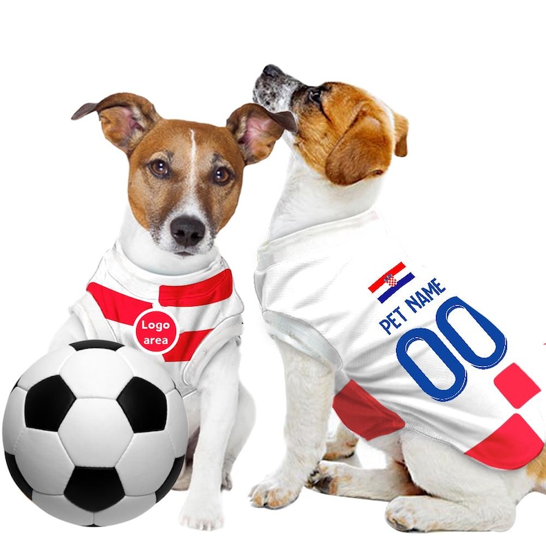 May include: Two dogs wearing white and red soccer jerseys with the Croatian flag on the back. One dog is holding a soccer ball. The jersey has the text "PET NAME" and "00" on the back.