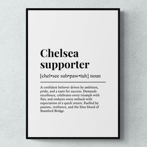May include: A framed print with the words "Chelsea supporter" in a bold, black font. The definition of a Chelsea supporter is provided below the title, describing their characteristics and values. The print is on a white background.