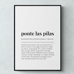 May include: A framed wall art print featuring the Spanish phrase ponte las pilas in bold black text on a white background. The print includes a phonetic pronunciation guide, the language origin, and a detailed definition of the phrase.