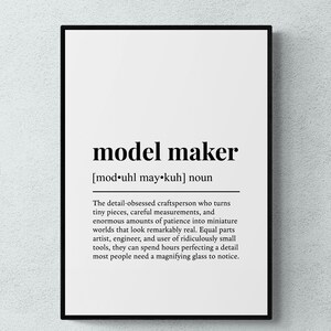 May include: A framed wall art print featuring a dictionary-style definition of the noun model maker. The text includes the phonetic pronunciation mod-uhl may-kuh and a paragraph describing a detail-obsessed craftsperson who creates miniature worlds.