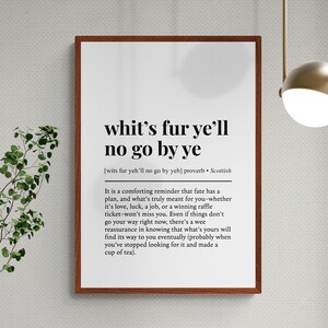 May include: A framed print with the text "whit's fur ye'll no go by ye", a Scottish proverb. The print has a white background with black text and a brown frame. The text is a comforting reminder about fate.
