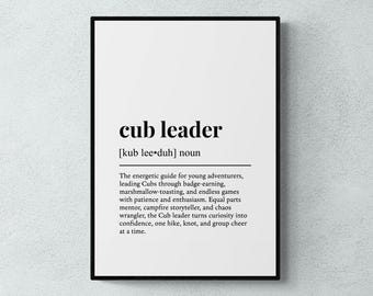 May include: A framed print with the words "cub leader" in bold black font. Below the title is the phonetic pronunciation and the word "noun". The definition of "cub leader" is printed below the title in a smaller font.