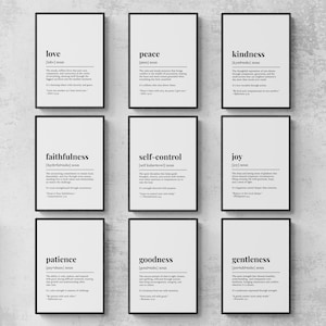 May include: Nine framed prints with black frames and white backgrounds. Each print displays a word in black, like "love" or "peace", and its definition. The prints are arranged in a grid formation.